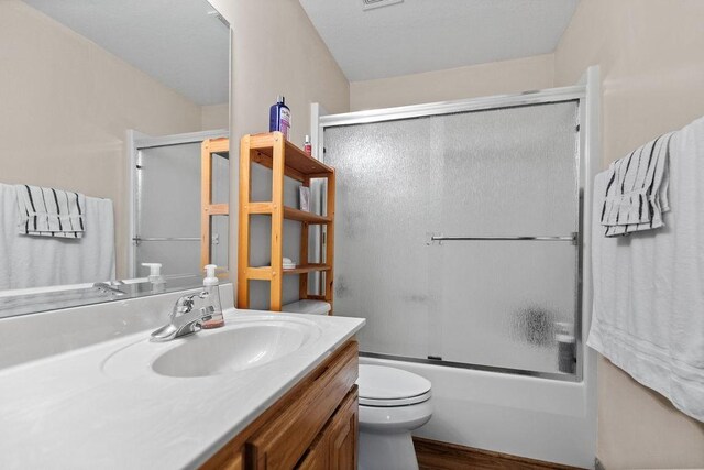 6 Portsmouth Ln, Bella Vista, AR 72715 - bathroom featuring toilet, enclosed tub / shower combo, vanity, and wood finished floors