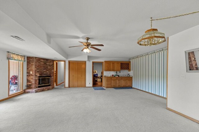 6 Portsmouth Ln, Bella Vista, AR 72715 - unfurnished living room featuring carpet floors, baseboards, a fireplace, and ceiling fan