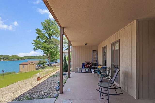 6 Portsmouth Ln, Bella Vista, AR 72715 - view of patio / terrace featuring a water view and an outbuilding
