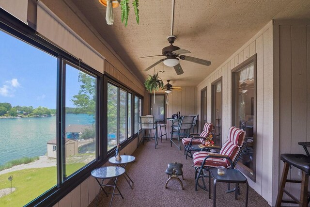 6 Portsmouth Ln, Bella Vista, AR 72715 - sunroom / solarium featuring carpet flooring, a water view, ceiling fan, and wood walls
