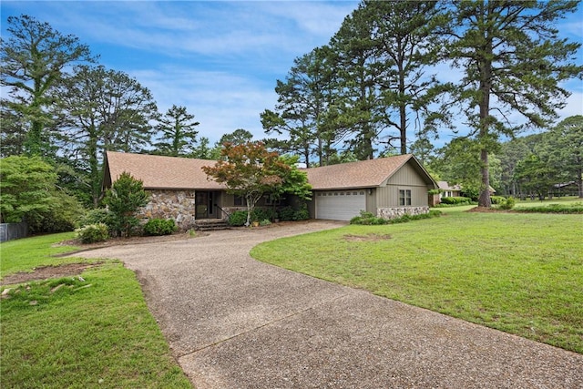 1433 Shalimar Cir, Russellville, AR 72802 - view of front of house with driveway, stone siding, a front yard, and a garage