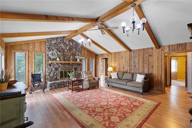 1433 Shalimar Cir, Russellville, AR 72802 - living area featuring a chandelier, plenty of natural light, wood walls, wood finished floors, and a fireplace
