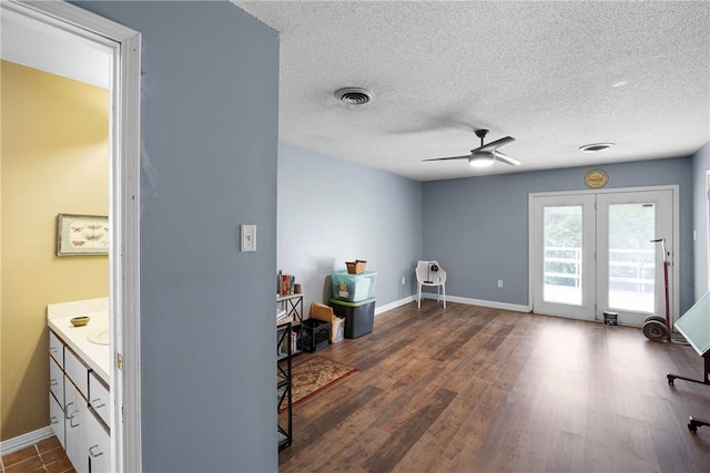 1433 Shalimar Cir, Russellville, AR 72802 - interior space with a ceiling fan, baseboards, a textured ceiling, and dark wood finished floors