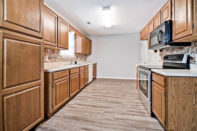 515 Jenkins Rd, Prairie Grove, AR 72753 - kitchen with stainless steel range with electric cooktop, white dishwasher, black microwave, baseboards, and tasteful backsplash