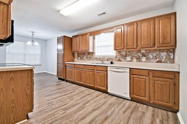 515 Jenkins Rd, Prairie Grove, AR 72753 - kitchen with white dishwasher, decorative backsplash, brown cabinetry, and light wood finished floors