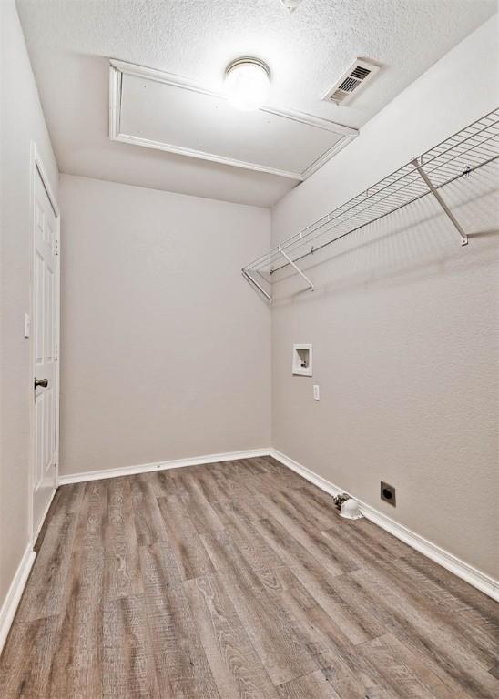 515 Jenkins Rd, Prairie Grove, AR 72753 - washroom with attic access, wood finished floors, hookup for a washing machine, a textured ceiling, and baseboards