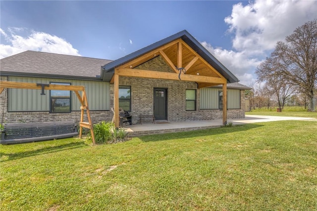 13865 State Highway 116, Colcord, OK 74338 - rear view of property with brick siding and a yard