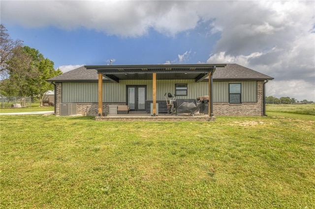 13865 State Highway 116, Colcord, OK 74338 - rear view of property featuring a yard, a patio, brick siding, and french doors
