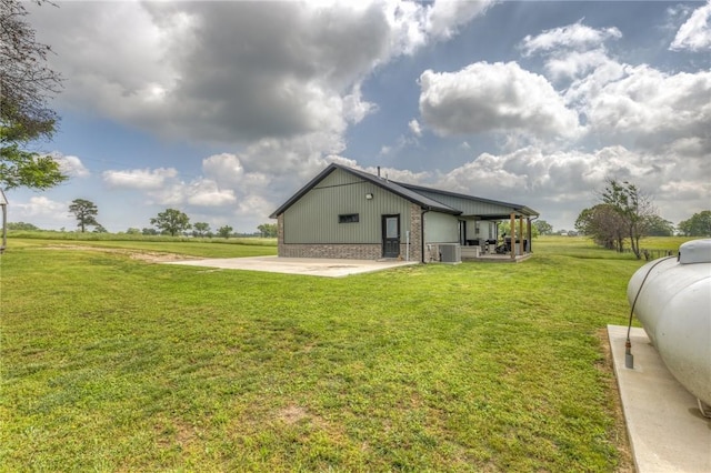 13865 State Highway 116, Colcord, OK 74338 - back of property featuring a yard, brick siding, and cooling unit