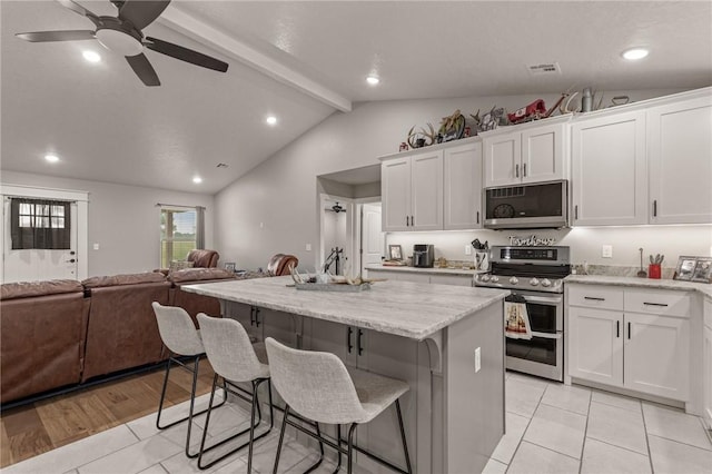 13865 State Highway 116, Colcord, OK 74338 - kitchen with appliances with stainless steel finishes, open floor plan, a center island, white cabinetry, and ceiling fan