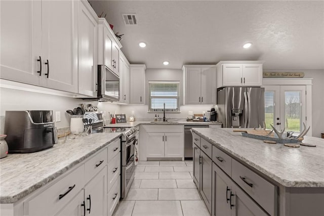 13865 State Highway 116, Colcord, OK 74338 - kitchen featuring stainless steel appliances, a sink, white cabinetry, a kitchen island, and recessed lighting