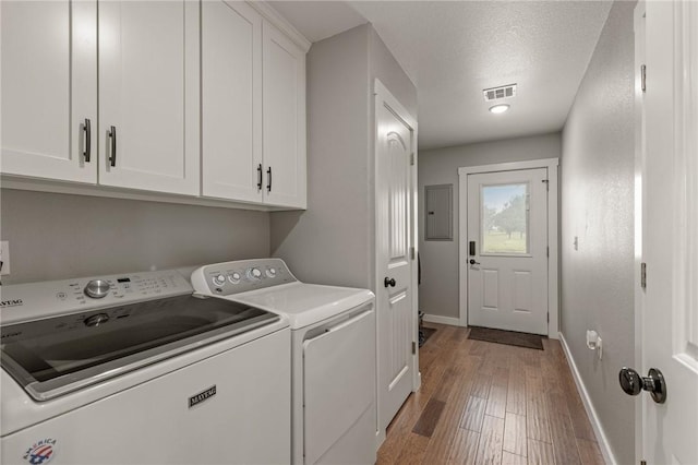 13865 State Highway 116, Colcord, OK 74338 - washroom with cabinet space, washing machine and dryer, baseboards, wood finished floors, and electric panel