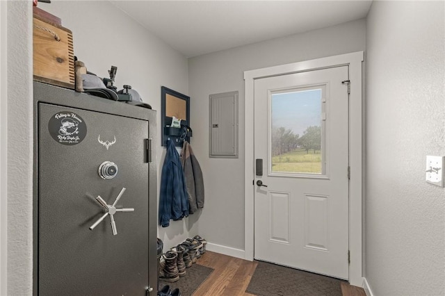 13865 State Highway 116, Colcord, OK 74338 - doorway to outside featuring wood finished floors, electric panel, and baseboards