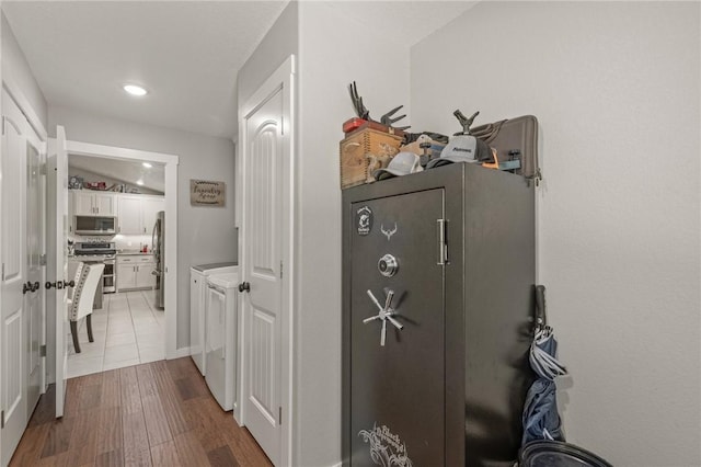 13865 State Highway 116, Colcord, OK 74338 - corridor featuring washing machine and clothes dryer, wood finished floors, and recessed lighting