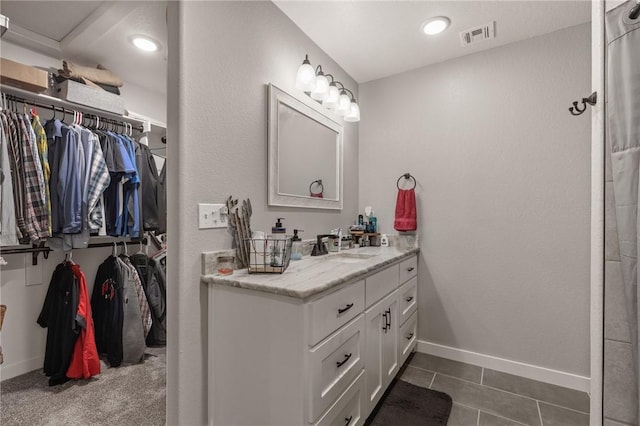 13865 State Highway 116, Colcord, OK 74338 - full bathroom with a spacious closet, vanity, baseboards, and tile patterned floors