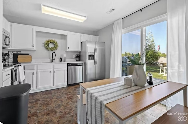 1500 Linwood Cir, Bentonville, AR 72712 - kitchen with appliances with stainless steel finishes, a sink, white cabinets, light countertops, and open shelves