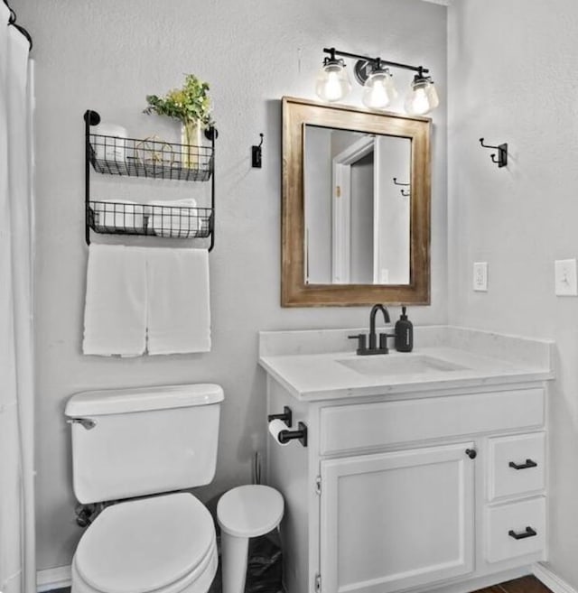 1500 Linwood Cir, Bentonville, AR 72712 - bathroom featuring toilet, vanity, and baseboards