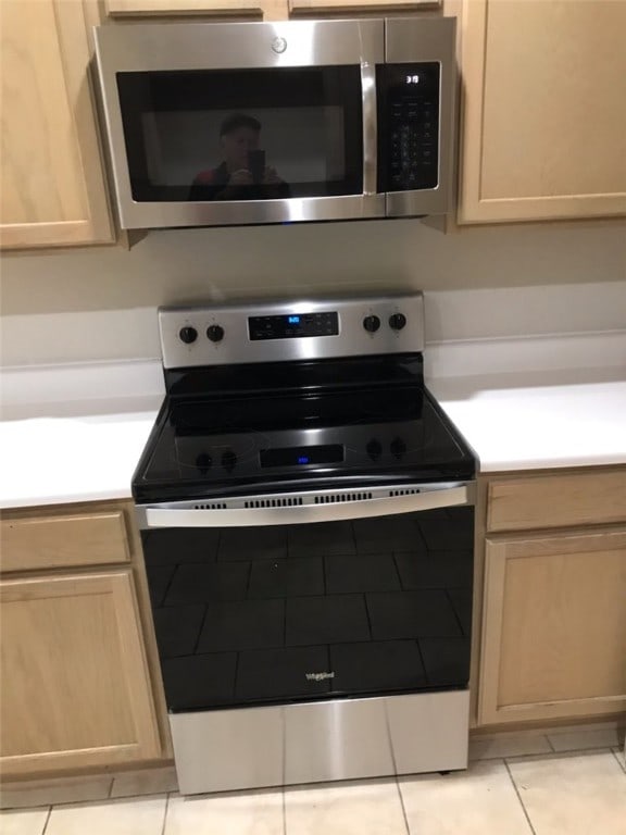 103-105 Dakota Trl, Farmington, AR 72730 - kitchen view of appliances with stainless steel finishes, light countertops, and light brown cabinetry