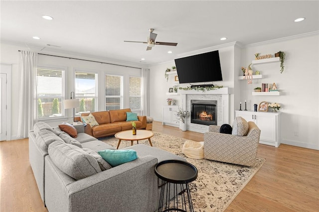 120 Bequette Ln, Centerton, AR 72719 - living room with ornamental molding, a ceiling fan, a glass covered fireplace, light wood-style flooring, and recessed lighting