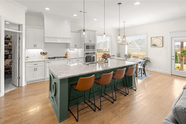 120 Bequette Ln, Centerton, AR 72719 - kitchen featuring stainless steel appliances, decorative backsplash, white cabinets, a breakfast bar, and recessed lighting