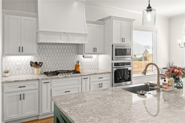120 Bequette Ln, Centerton, AR 72719 - kitchen with appliances with stainless steel finishes, custom exhaust hood, a sink, white cabinets, and backsplash