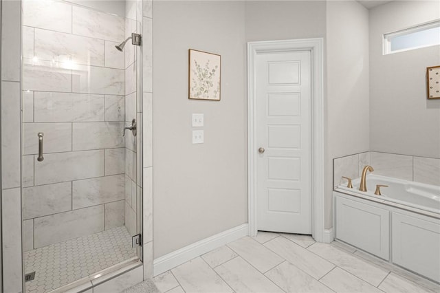 120 Bequette Ln, Centerton, AR 72719 - bathroom featuring a stall shower, a garden tub, baseboards, and marble look tiles