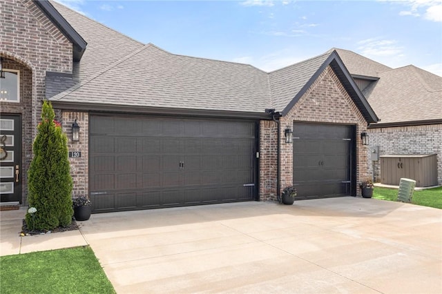 120 Bequette Ln, Centerton, AR 72719 - view of front of home with brick siding, a garage, concrete driveway, and a shingled roof