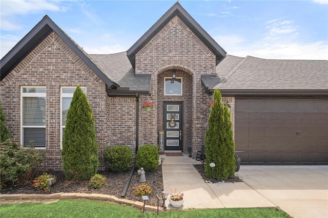 120 Bequette Ln, Centerton, AR 72719 - french country home with brick siding, roof with shingles, a garage, and driveway