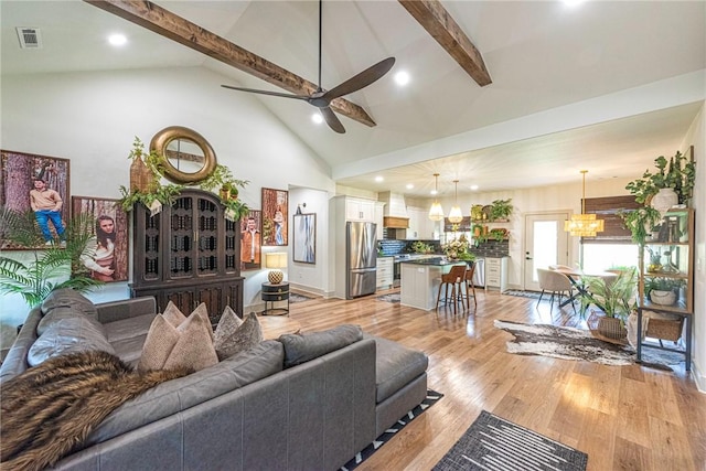 852 Round Top St, Prairie Grove, AR 72753 - living room featuring a chandelier, beam ceiling, a ceiling fan, high vaulted ceiling, and light wood-type flooring