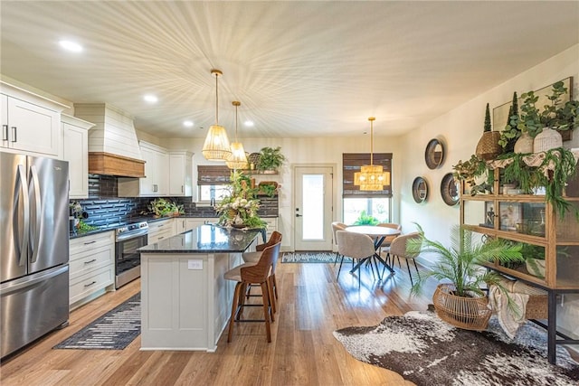 852 Round Top St, Prairie Grove, AR 72753 - kitchen featuring stainless steel appliances, custom exhaust hood, a chandelier, a center island, and a kitchen breakfast bar