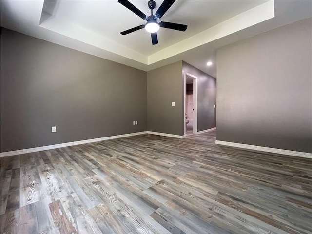 2103 Highland Ct, Dardanelle, AR 72834 - spare room with a tray ceiling, a ceiling fan, wood finished floors, baseboards, and recessed lighting