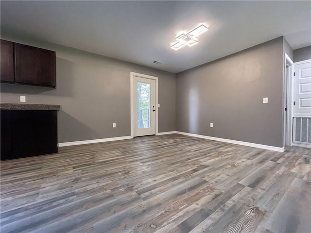 2103 Highland Ct, Dardanelle, AR 72834 - unfurnished living room with baseboards and wood finished floors