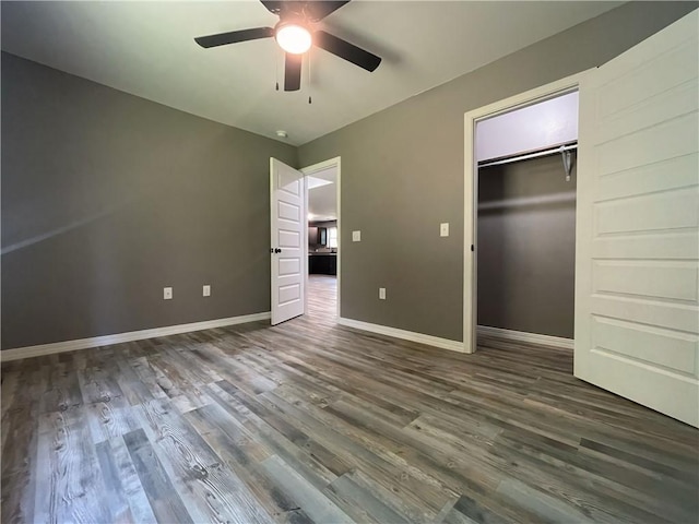 2103 Highland Ct, Dardanelle, AR 72834 - unfurnished bedroom featuring dark wood-style floors, baseboards, a closet, and ceiling fan