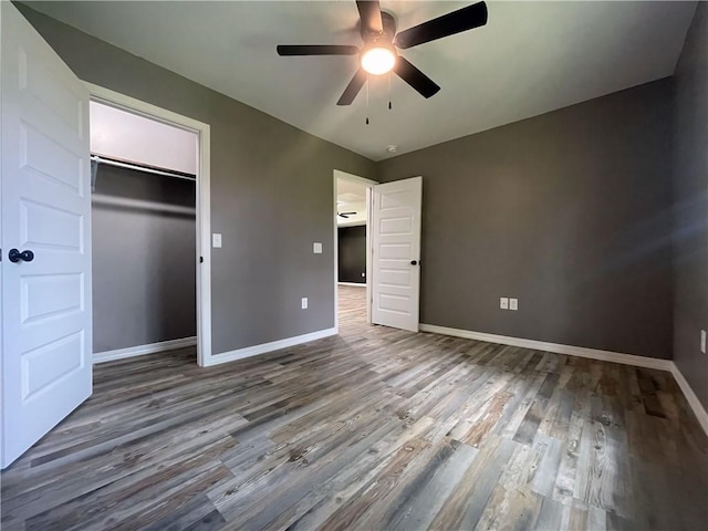 2103 Highland Ct, Dardanelle, AR 72834 - unfurnished bedroom with wood finished floors, baseboards, a closet, and a ceiling fan