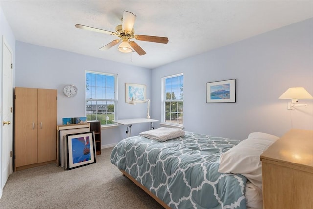 33 Holiday Island Dr, Holiday Island, AR 72631 - carpeted bedroom with multiple windows, a ceiling fan, and baseboards