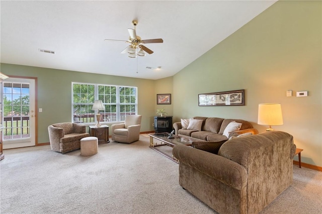 33 Holiday Island Dr, Holiday Island, AR 72631 - carpeted living room with ceiling fan, a wood stove, baseboards, healthy amount of natural light, and vaulted ceiling
