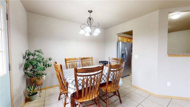509 SW Persimmon St, Gravette, AR 72736 - dining space with a chandelier, light tile patterned floors, and baseboards