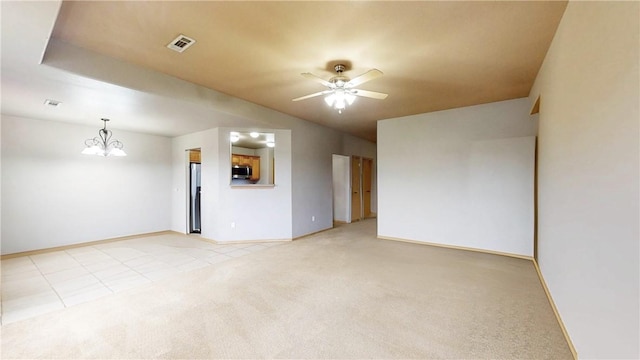509 SW Persimmon St, Gravette, AR 72736 - spare room with a chandelier, light carpet, a ceiling fan, and baseboards