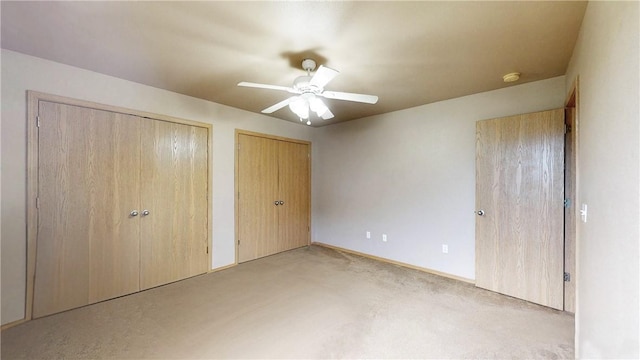 509 SW Persimmon St, Gravette, AR 72736 - unfurnished bedroom featuring multiple closets, light colored carpet, ceiling fan, and baseboards