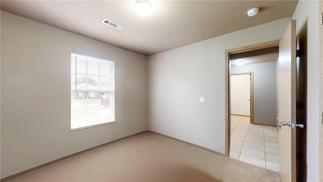 509 SW Persimmon St, Gravette, AR 72736 - unfurnished room with a smoke detector, light carpet, and light tile patterned flooring