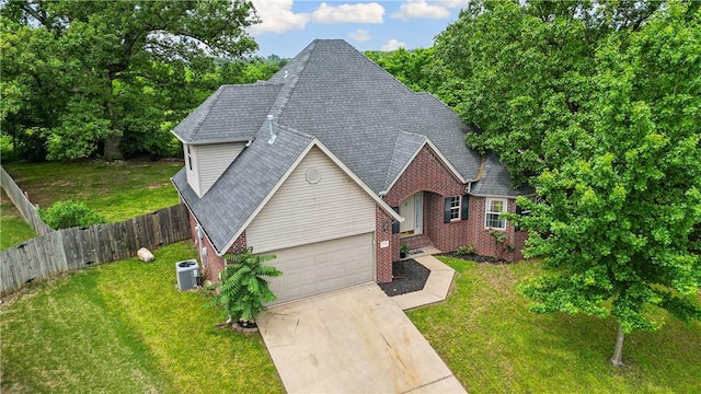 4730 Woodside Ln, Springdale, AR 72762 - traditional home featuring brick siding, central AC, a shingled roof, and a garage