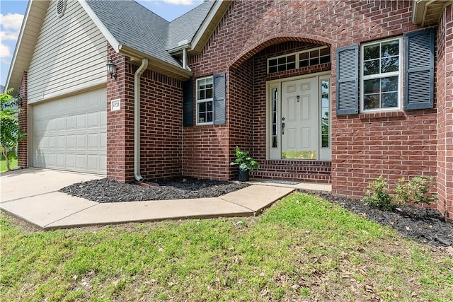 4730 Woodside Ln, Springdale, AR 72762 - view of exterior entry featuring brick siding, roof with shingles, driveway, and an attached garage