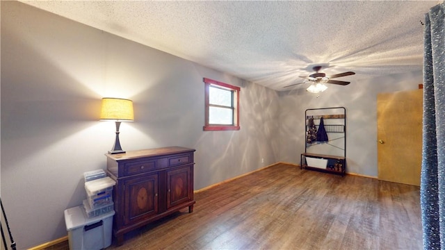 104 NE Deer Ridge Rd, Gravette, AR 72736 - unfurnished room with wood finished floors, ceiling fan, a textured ceiling, and baseboards