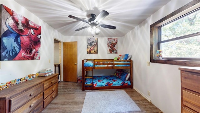 104 NE Deer Ridge Rd, Gravette, AR 72736 - bedroom featuring wood finished floors and a ceiling fan