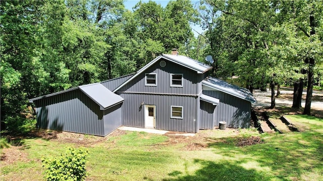 104 NE Deer Ridge Rd, Gravette, AR 72736 - rear view of property featuring a chimney and a yard