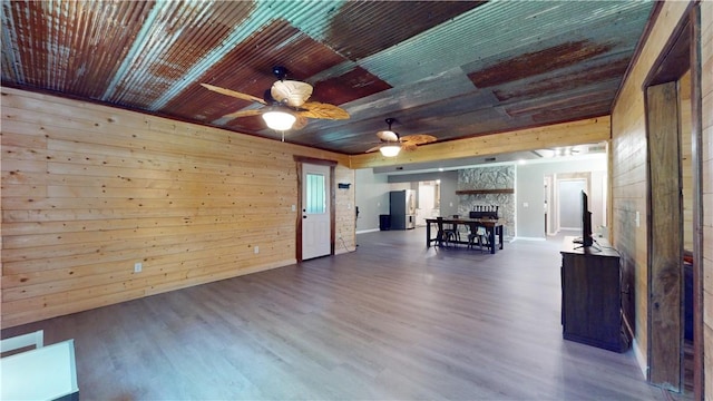 104 NE Deer Ridge Rd, Gravette, AR 72736 - living area featuring a ceiling fan, wood finished floors, wood walls, wooden ceiling, and baseboards