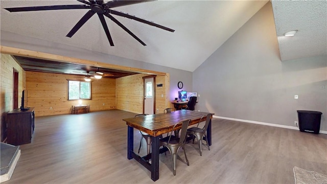 104 NE Deer Ridge Rd, Gravette, AR 72736 - dining area with wood walls, a ceiling fan, wood finished floors, baseboards, and a textured ceiling