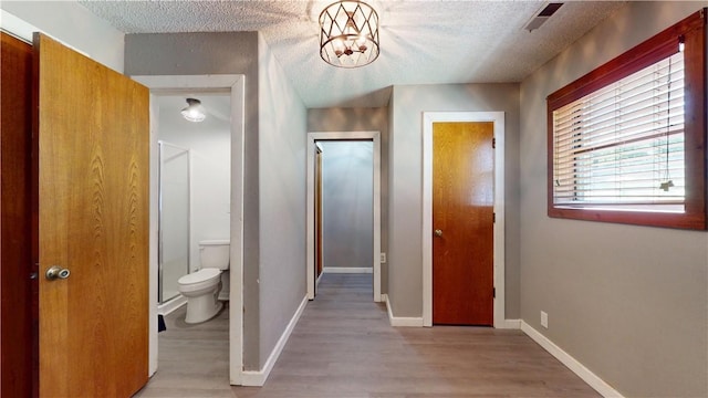 104 NE Deer Ridge Rd, Gravette, AR 72736 - corridor with a textured ceiling, light wood-style floors, and baseboards