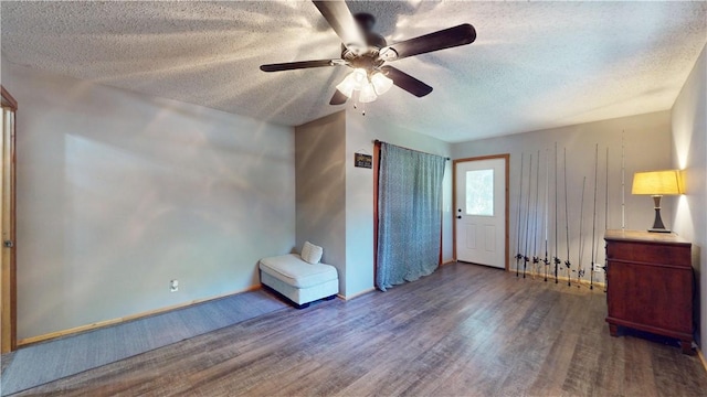 104 NE Deer Ridge Rd, Gravette, AR 72736 - unfurnished bedroom featuring wood finished floors, a textured ceiling, baseboards, and ceiling fan
