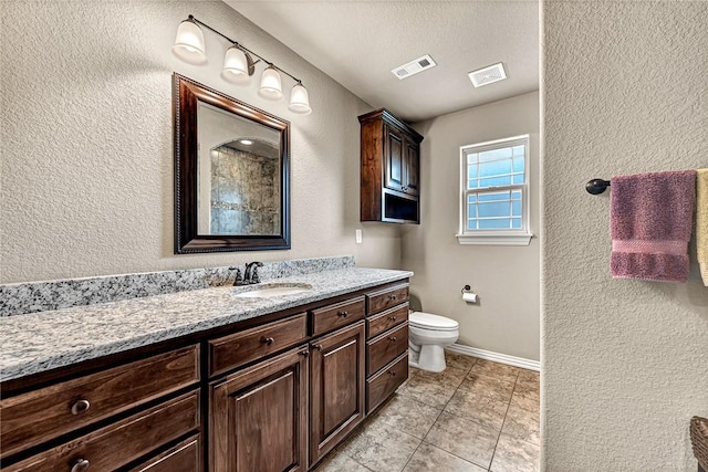 1805 SW Birch St, Bentonville, AR 72713 - bathroom with toilet, vanity, a textured wall, tile patterned flooring, and baseboards